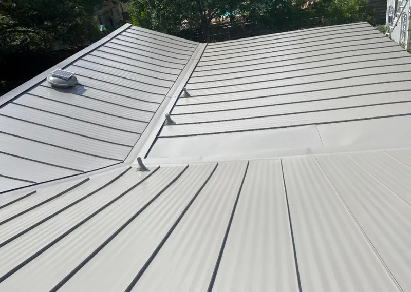 Solar attic fan installed on a metal roof for Roof Ventilation in Inkster